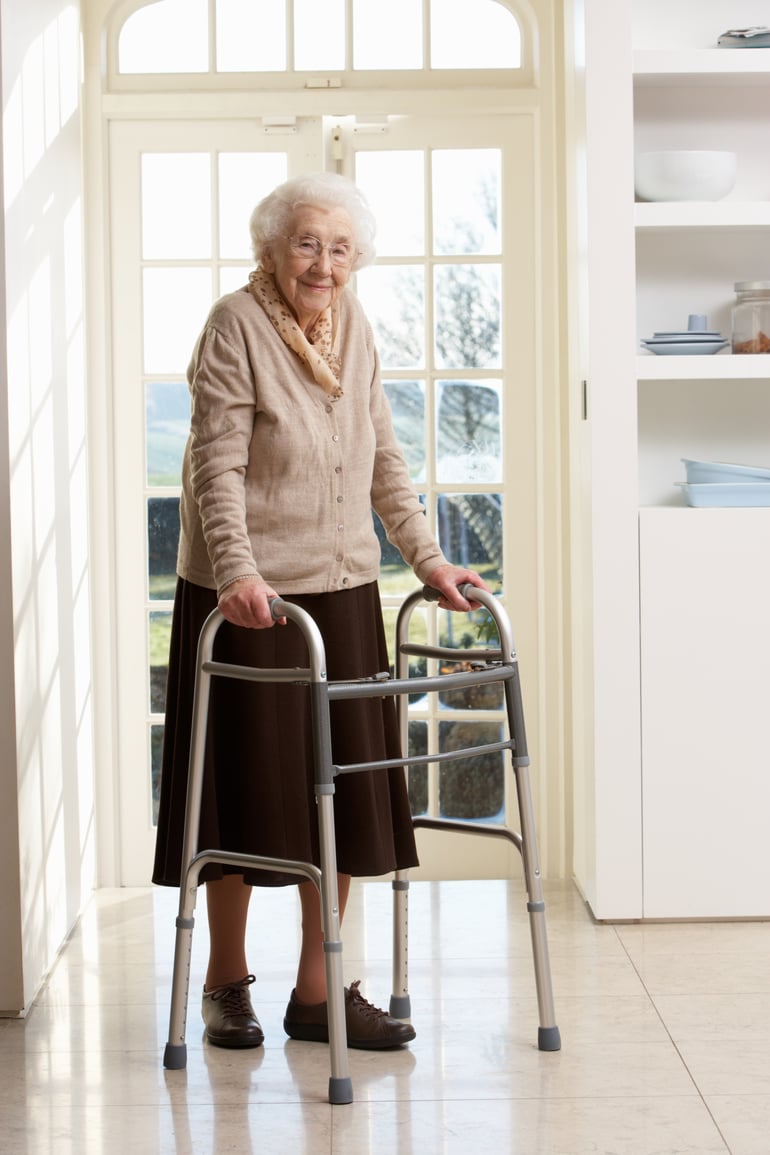 elderly-senior-woman-using-walking-frame-P9WQQ69